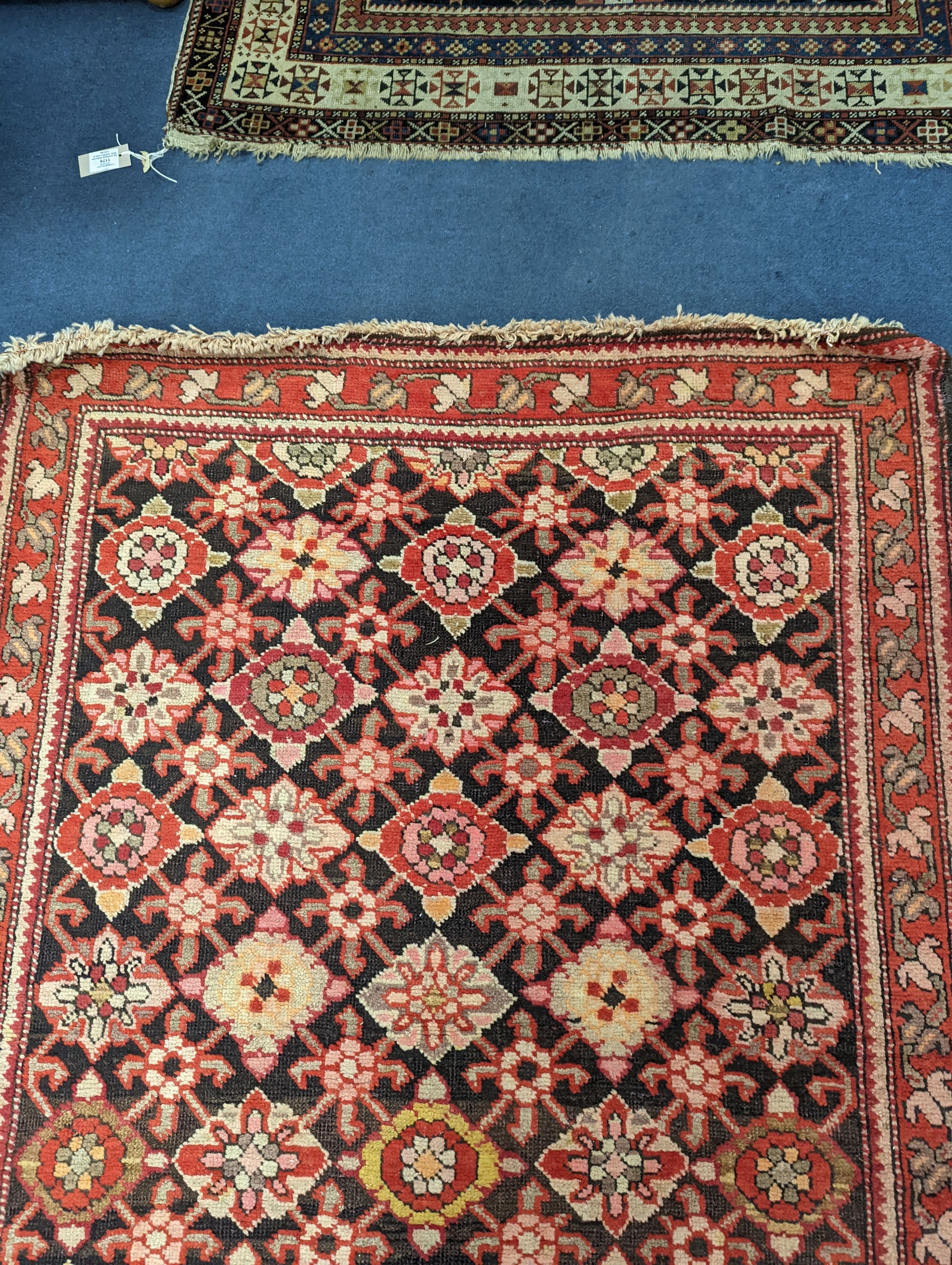 A North West Persian runner woven with rows of floral motifs, 575 x 110cm